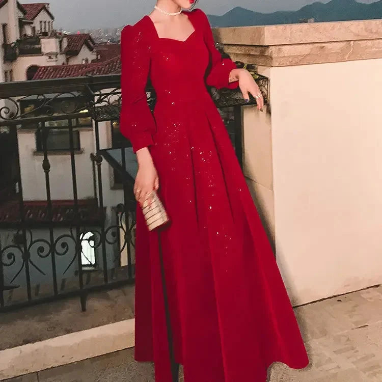 Elegant red luxury ceremony gown by Luxlife Brands, featuring intricate details and flowing fabric for formal events.