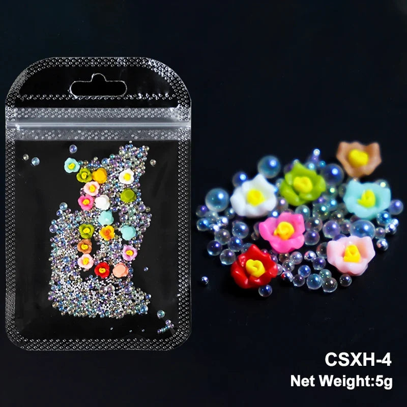 White acrylic flower nail art decorations with mixed size rhinestones and colorful gems for DIY manicure design.