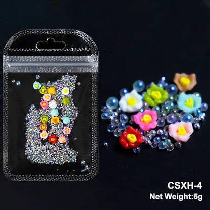 White acrylic flower nail art decorations with mixed size rhinestones and colorful gems for DIY manicure design.