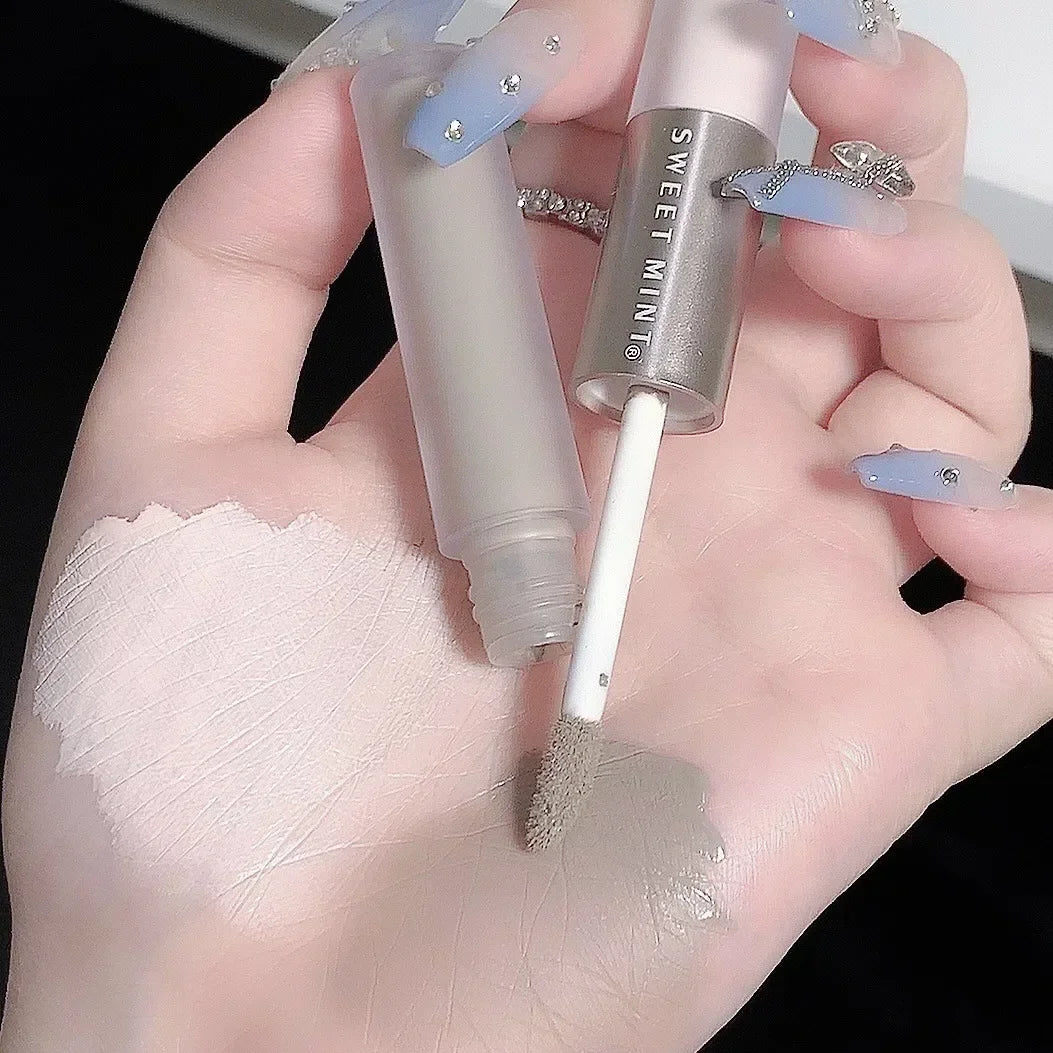Blushimmer double-ended highlighting and contouring stick with concealer pencil, in cement grey for nose shadow and bronzer makeup.
