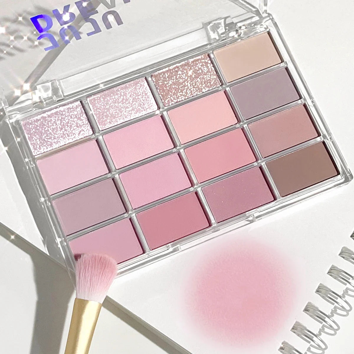 Blushimmer 16-color eyeshadow palette with pearlescent and matte earth tones for natural, everyday makeup looks.