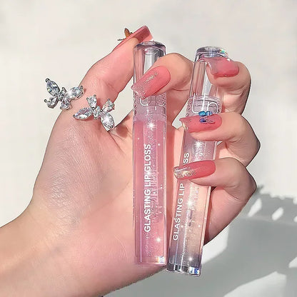 Blushimmer transparent glass lip gloss with water-inspired shine, glossy finish, and waterproof, long-lasting liquid lipstick on lips.