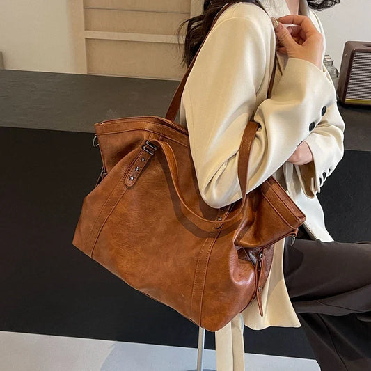 Brown leather women's tote shoulder crossbody bag by OBA, featuring versatile design and spacious interior for everyday use.