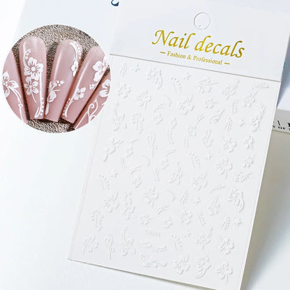 White and black 3D hibiscus flower nail stickers by Blushimmer with pink and gold floral designs for nail art decoration.
