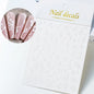 White and black 3D hibiscus flower nail stickers by Blushimmer with pink and gold floral designs for nail art decoration.
