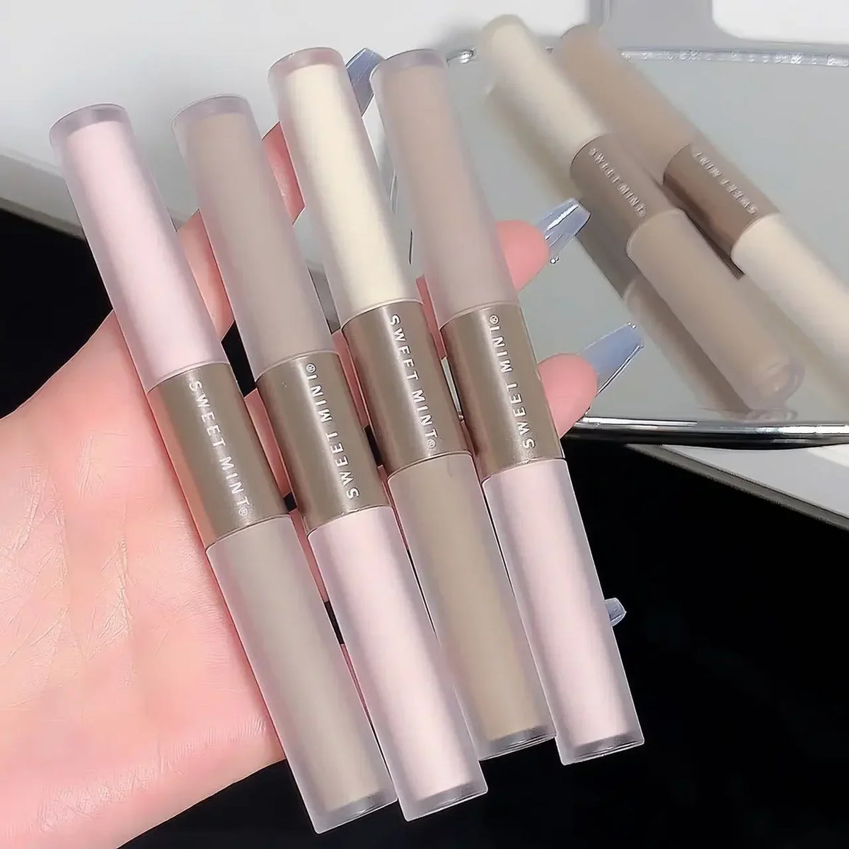 Blushimmer double-ended highlighting and contouring stick with concealer and bronzer pencils, featuring a cement grey shade for nose shading.