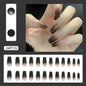 Set of 24 Y2K star press-on nails by Blushimmer featuring gradient black mid-length coffin tips with moon designs