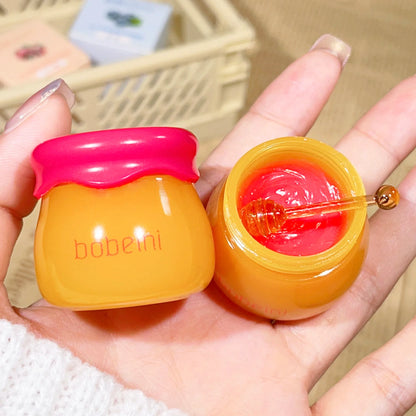 Blushimmer Hydrating Peach & Honey Lip Mask in a jar, showcasing its creamy texture and natural peach and honey ingredients.