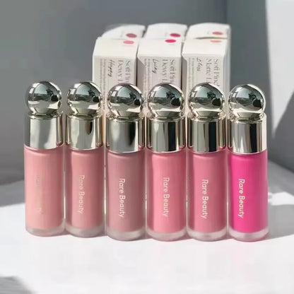 Blushimmer Rare Beauty melting cream blush with matte and pearlescent finish, highlighter, and moisturizing lip gloss in a sleek container.