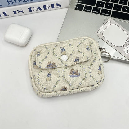 Cute cartoon small travel makeup bag by Blushimmer with compartments for lipstick, earphones, and cards in a portable purse style.