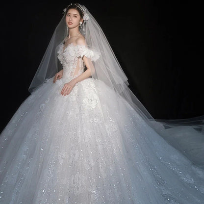 Luxurious EdleessFashion wedding gown with shiny applique and sweetheart neckline, perfect for elegant bridal attire.