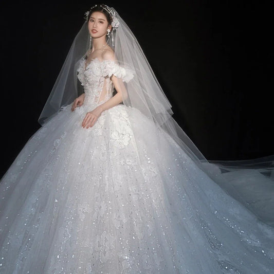 Luxurious EdleessFashion wedding gown with shiny applique and sweetheart neckline, perfect for elegant bridal attire.