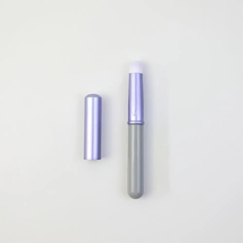 Blushimmer portable gold and silver lip gloss brush pen with metal handle and protective cap, ideal for applying lipstick and lip gloss.