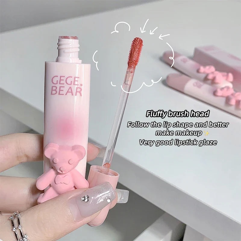 Blushimmer cute bear lip glaze mist and matte velvet lipstick with whitening and color-enhancing lip cream, held in hand.