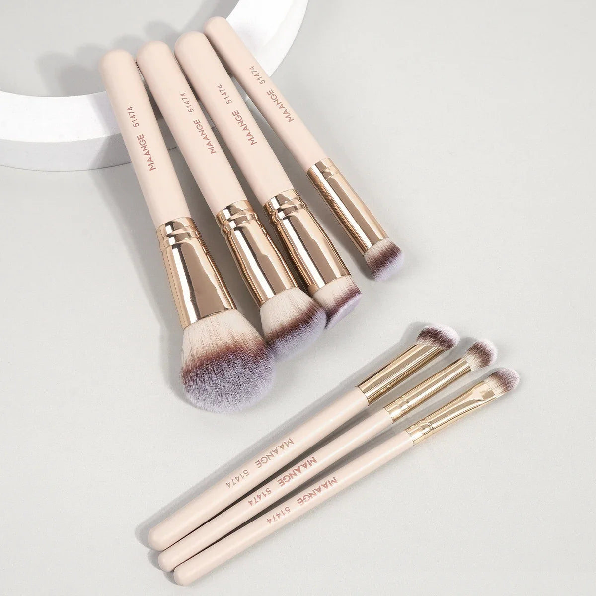 Set of 7 Blushimmer makeup brushes with soft bristles for foundation, powder, concealer, and blush application.