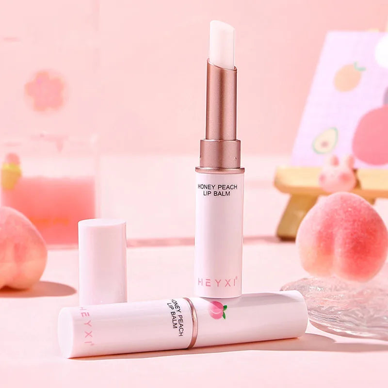 Blushimmer Honey Peach lip balm showing a color-changing, moisturizing lipstick on smooth lips with a glossy finish.