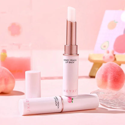 Blushimmer Honey Peach lip balm showing a color-changing, moisturizing lipstick on smooth lips with a glossy finish.