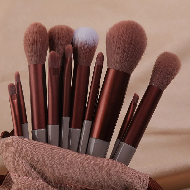 Set of 13 Blushimmer makeup brushes including eyeshadow, foundation, blush, and cosmetic brushes in a soft makeup tools bag.