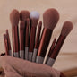 Set of 13 Blushimmer makeup brushes including eyeshadow, foundation, blush, and cosmetic brushes in a soft makeup tools bag.