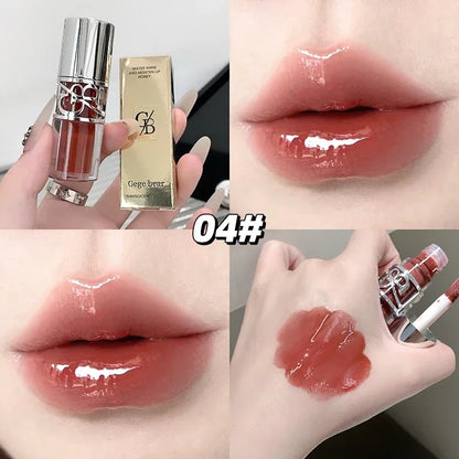 Clear glass shine lip gloss by Blushimmer with watery, moisturizing finish and juicy tint, featuring a mirror for easy application.