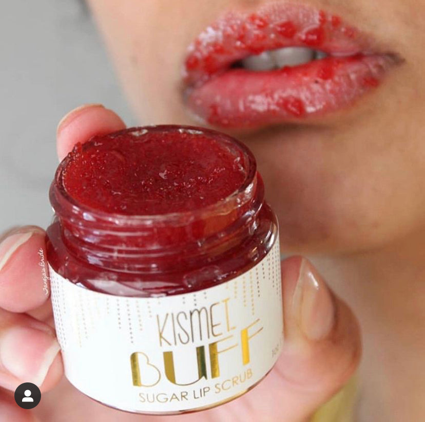 Kismet Buff All-Natural Lip Scrub in a clear jar with a spoon, showcasing exfoliating sugar and natural ingredients for smooth lips.