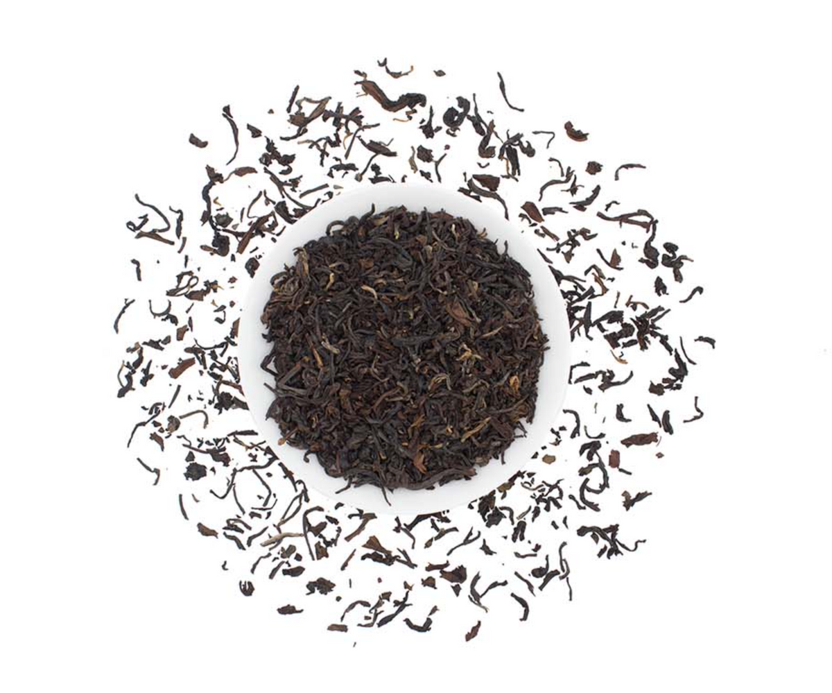 Organic Nepalese black tea loose leaf from Good Brothers Coffee LLC, showing rich dark tea leaves in a close-up view.