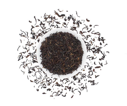 Organic Nepalese black tea loose leaf from Good Brothers Coffee LLC, showing rich dark tea leaves in a close-up view.