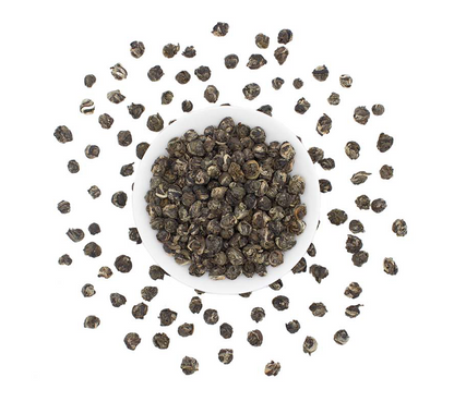 Loose leaf Jasmine Pearls green tea from Good Brothers Coffee LLC, showing fresh green tea pearls in a clear container.