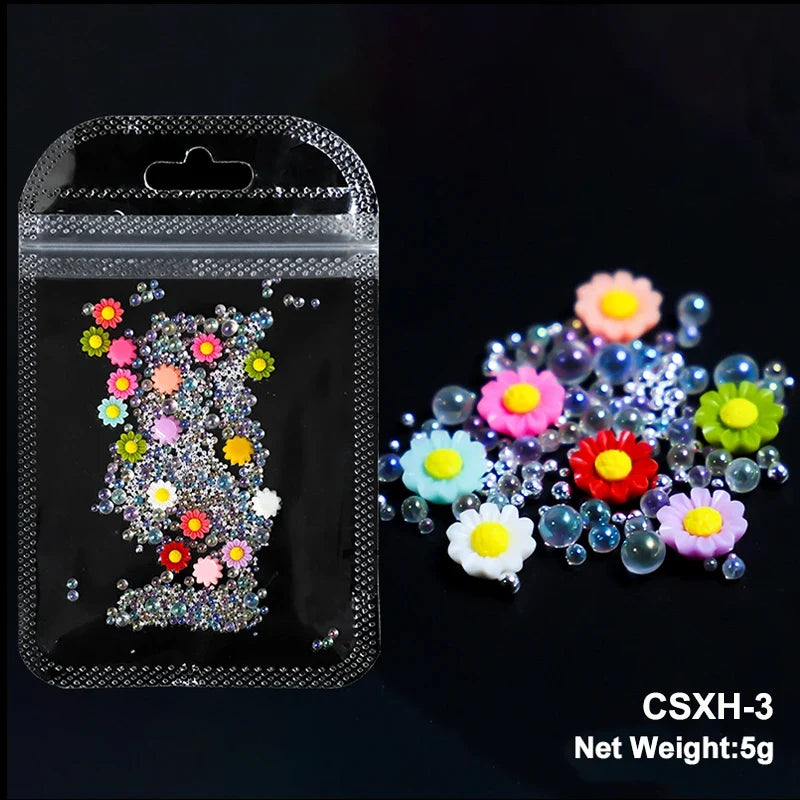 White acrylic flower nail art decorations with mixed size rhinestones and colorful gems for manicure DIY accessories.