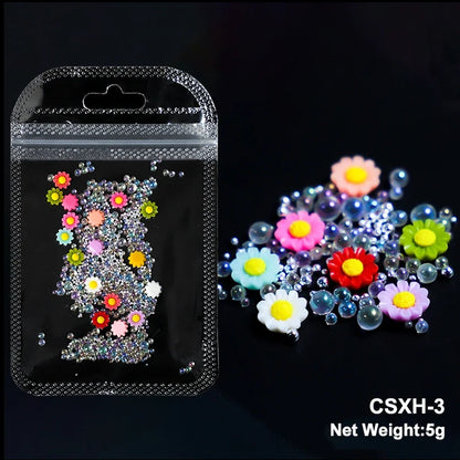 White acrylic flower nail art decorations with mixed size rhinestones and colorful gems for manicure DIY accessories.