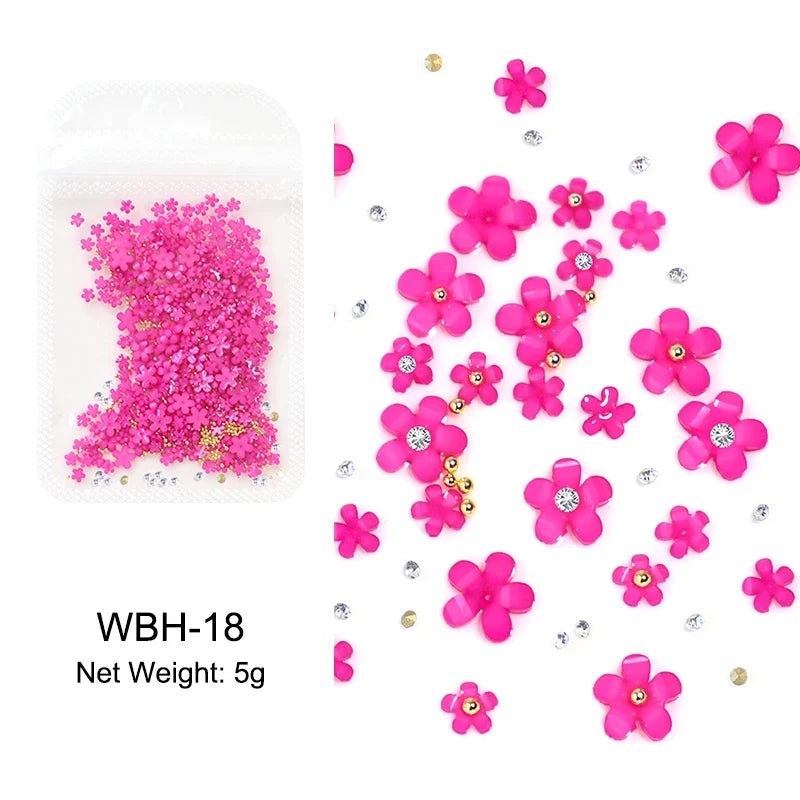 White acrylic flower nail art decorations with mixed-size red and blue rhinestones for DIY manicure design, by Blushimmer.