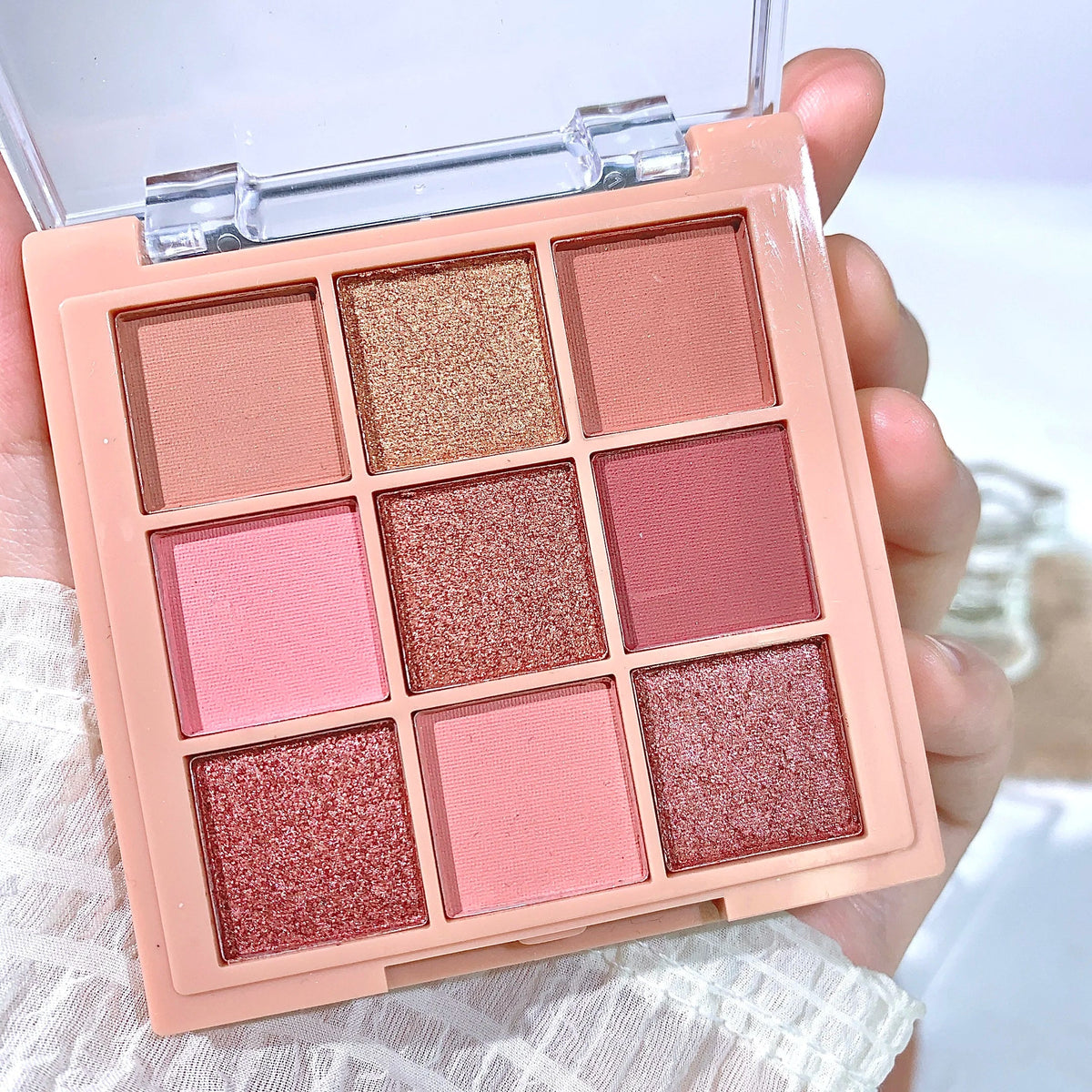 Blushimmer warm winter eyeshadow palette with nine earth tone shades in orange, brown, and milk tea colors.