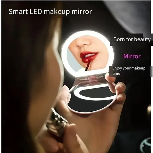 Pink compact LED pocket mirror with 1X/3X magnification, illuminated, featuring a USB charging cable, perfect for purse or travel.