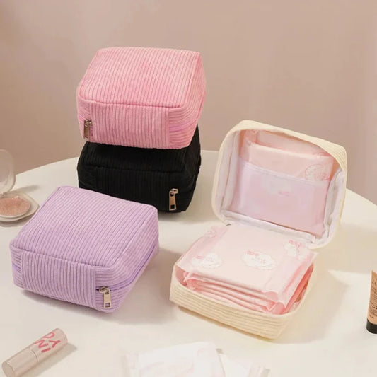Blushimmer sanitary napkins organizer bag with compartments for makeup, lipstick, earphones, and travel essentials in a compact design.