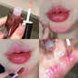 Blue mermaid color pearlescent lip gloss by Blushimmer showing shiny, glittery lips with a glossy, shimmering finish and waterproof formula.