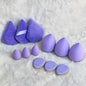 Set of 12 Blushimmer powder puff triangles made of soft velour for setting and blending loose or foundation powder.