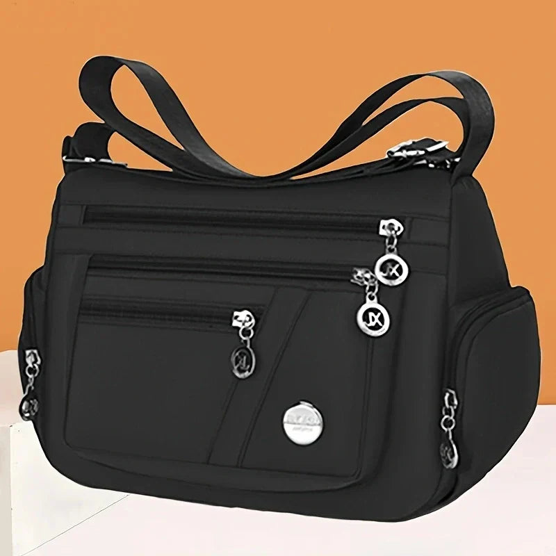 Black OBA ladies crossbody travel handbag with adjustable strap and sleek design, perfect for everyday use.