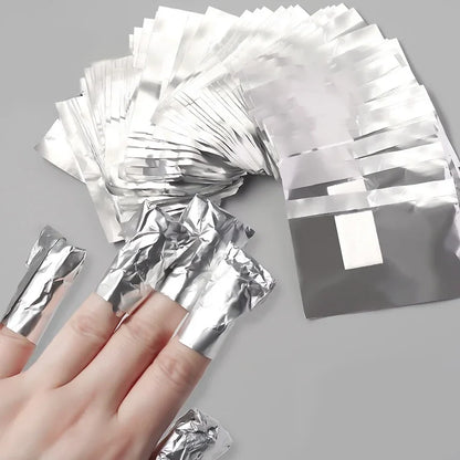 Set of 100 Blushimmer aluminium foil nail art wraps for soak-off gel polish removal with towels and manicure tools.