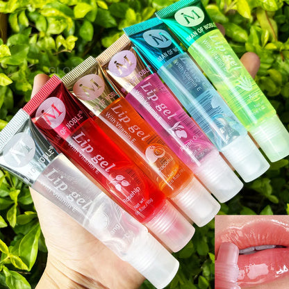 Blushimmer 6-pack fruity flavor watery glossy lip gloss set showing clear, hydrating lip gels on lips with vibrant fruit design.