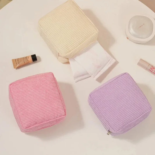 Blushimmer sanitary napkins organizer bag with compartments for makeup, lipstick, earphones, and travel essentials in a compact design.