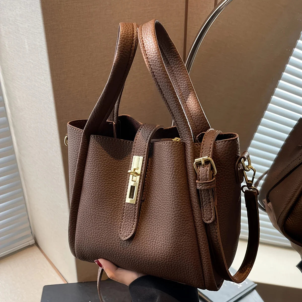 NNEOBA women's multifunctional crossbody handbag in black with adjustable strap and multiple compartments for everyday use.