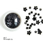 White acrylic flower nail art decorations with mixed size rhinestones and colorful gems for DIY manicure designs.