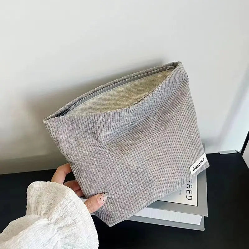 Large capacity Blushimmer corduroy makeup bag with lipstick, phone, and change compartments, handheld design for women.