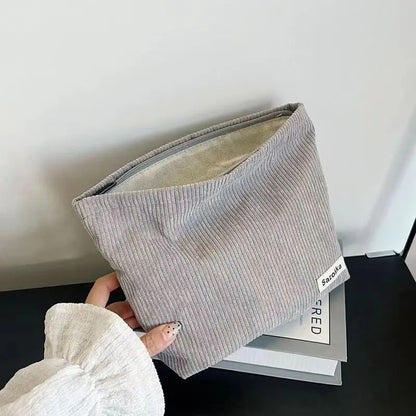 Large capacity Blushimmer corduroy makeup bag with lipstick, phone, and change compartments, handheld design for women.