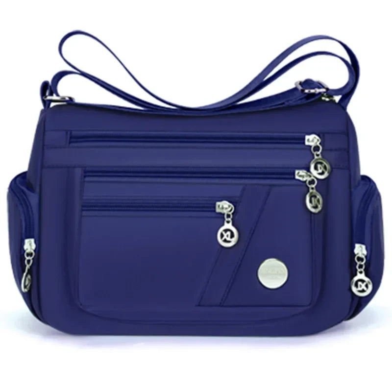 Blue OBA ladies crossbody travel handbag with adjustable strap and front zipper pocket, stylish and functional for everyday use.