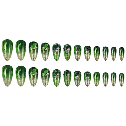 Set of 24 glossy almond false nails by Blushimmer with dark green forest mushroom pattern, gold sequins, and French style design.
