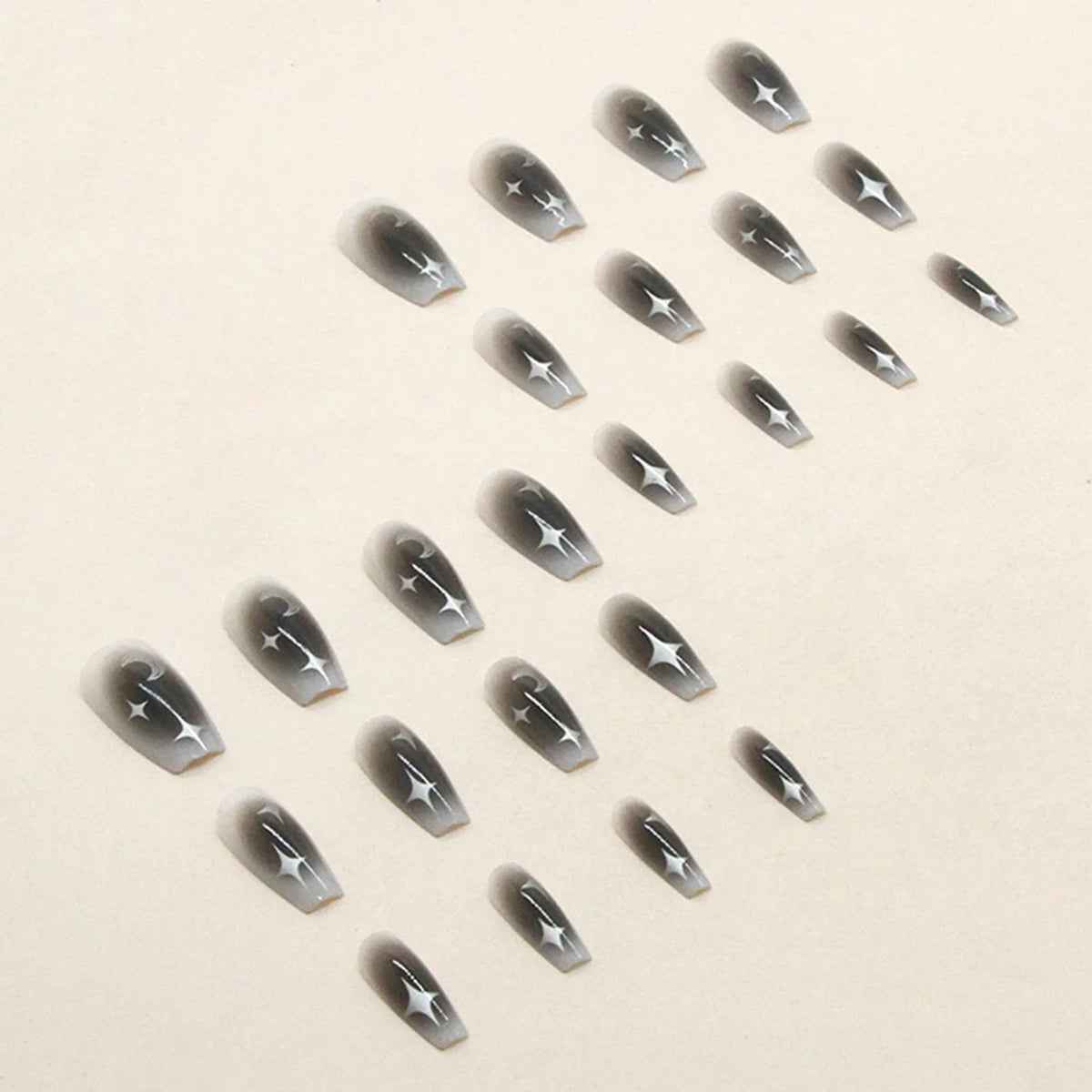 Set of 24 Y2K star and moon design press on false nails by Blushimmer, black gradient mid-length coffin tips for a stylish look.