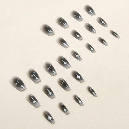 Set of 24 Y2K star and moon design press on false nails by Blushimmer, black gradient mid-length coffin tips for a stylish look.