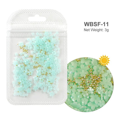 White acrylic flower nail art decorations with mixed size rhinestones, red and blue gems for DIY manicure nail design accessories.