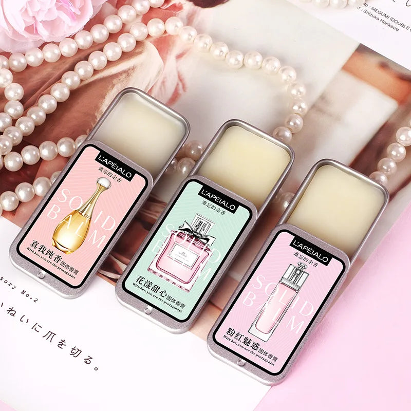 Woman's Blushimmer pheromone perfume solid balm in a portable, long-lasting fragrance container with a light, subtle scent.